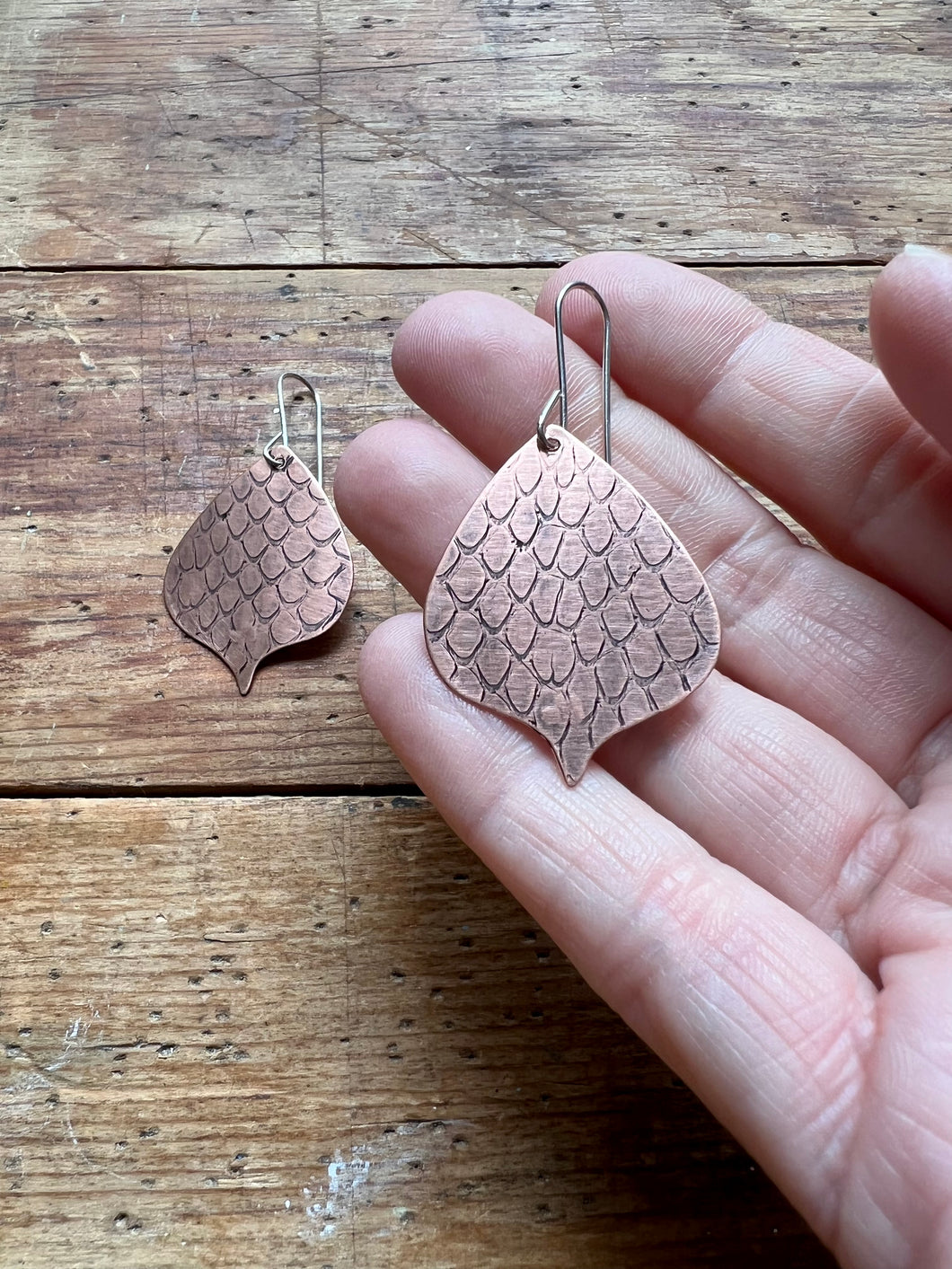 Copper earrings with pressed snake shedding